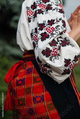 Ukrainian traditional national costume closeup: embroidered shirt, vyshyvanka, skirt, woven belt. Culture of Ukraine