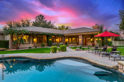 sunset over a luxury home pool  photo
