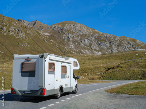VR Caravan family car on vocation in Dolomites Alps with rocky mountains on a background . Beautiful nature in early autumn season.