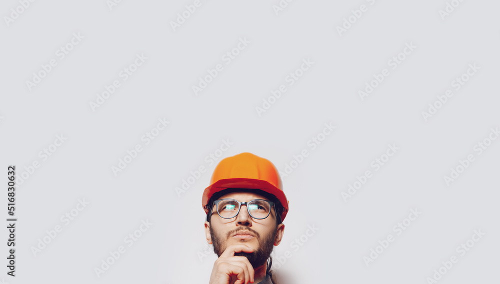 Portrait of young construction worker on white. Panoramic banner, copy space. Portrait of young construction worker on white. Panoramic banner, copy space.