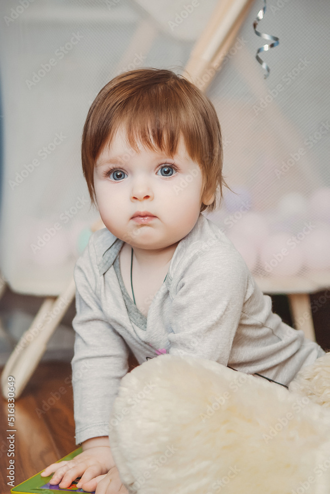 Fototapeta premium baby girl playing with toys in children's room