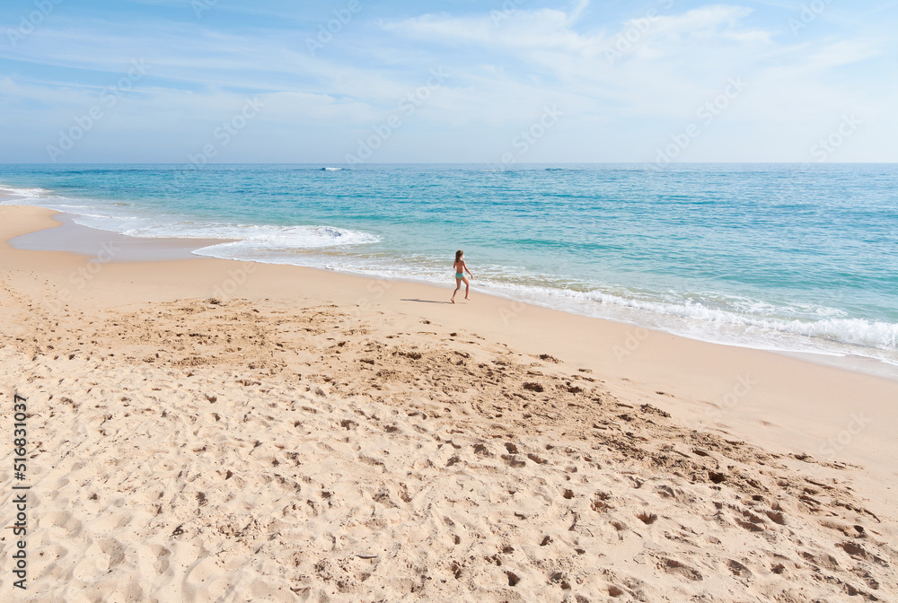 Alone girl running into the sea