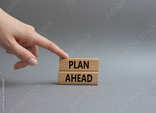 Plan ahead symbol. Wooden blocks with words Plan ahead. Beautiful grey background. Businessman hand. Business and 'Plan ahead' concept. Copy space.