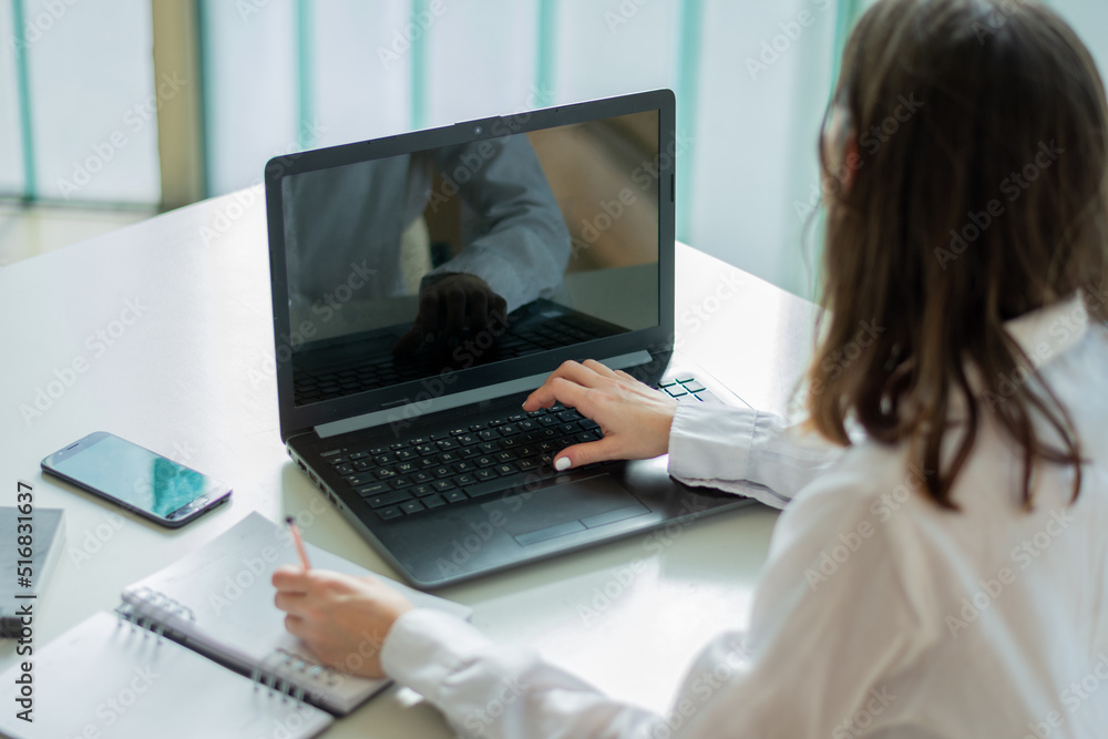 Businesswoman uses her laptop in a co-working office Businesswoman uses her laptop in a co-working office