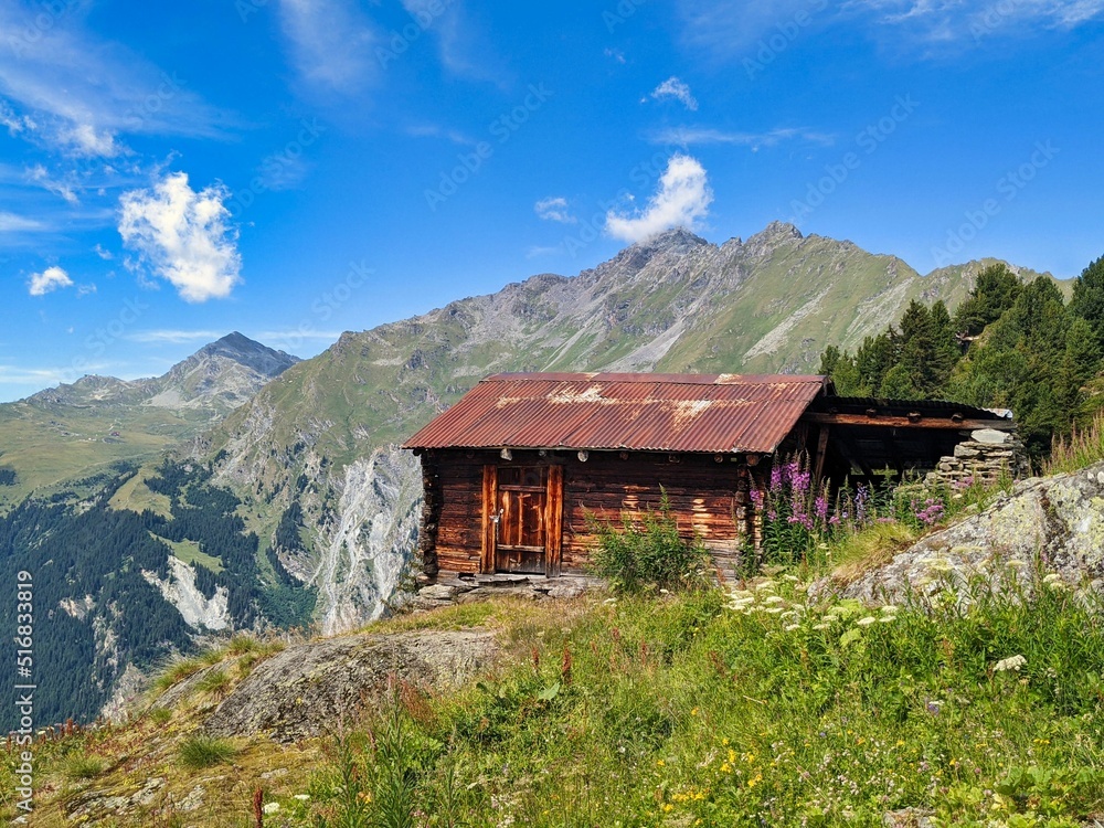 old alpine hut in the valais mountains. Hut in the swiss alps with a beautiful view of the mountains. High quality photo
