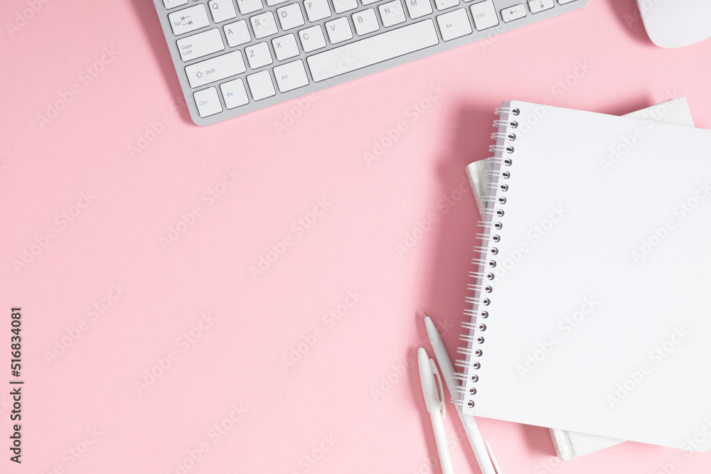 Styled stock pink office desk table with blank notebook, stationery, keyboard. Business minimal concept for women. Flat lay, top view, copy space Styled stock pink office desk table with blank notebook, stationery, keyboard. Business minimal concept for women. Flat lay, top view, copy space