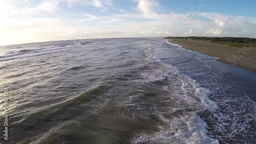 Aerial view of the sea and beach at sunset