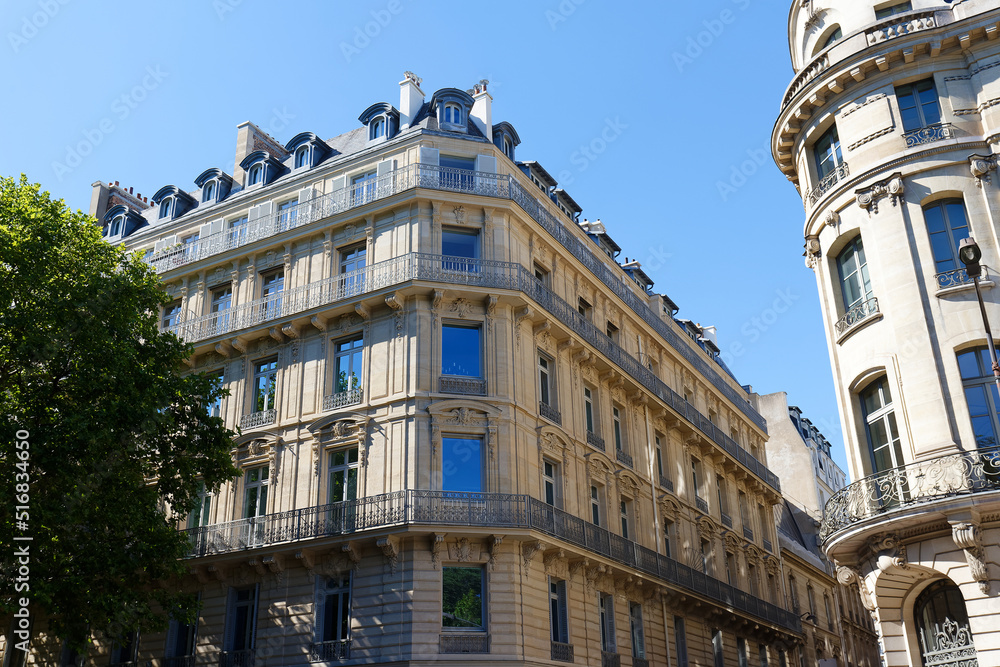 Fototapeta premium The facades of traditional French houses with typical balconies and windows. Paris.
