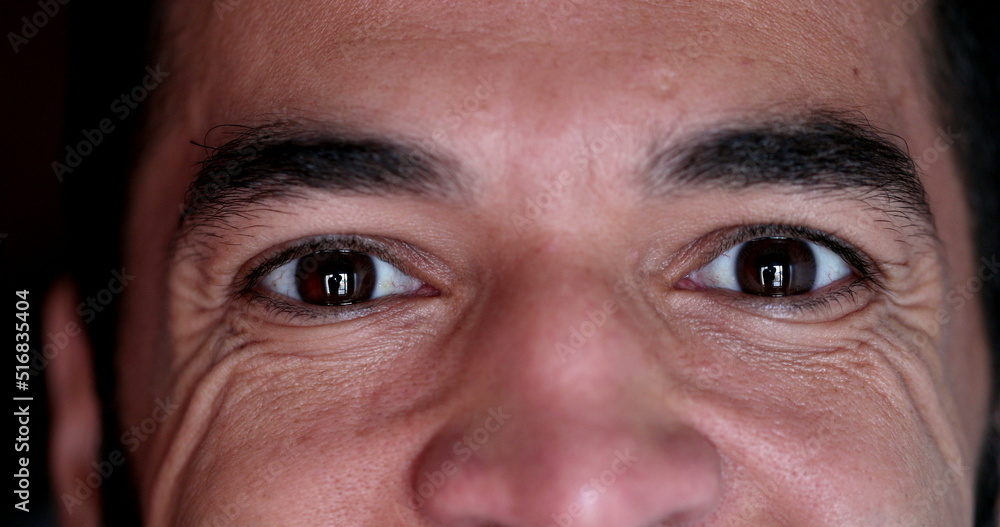 Close-up man eyes smiling. Wrinkled man in 40s looking at camera macro closeup