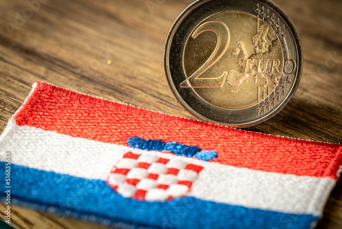 Fototapeta Naklejka Na Ścianę i Meble -  Croatian flag next to the euro coin. Croatia's accession to the Euro zone. Concept, Flag of the Country, Political and economic concept of the European Union