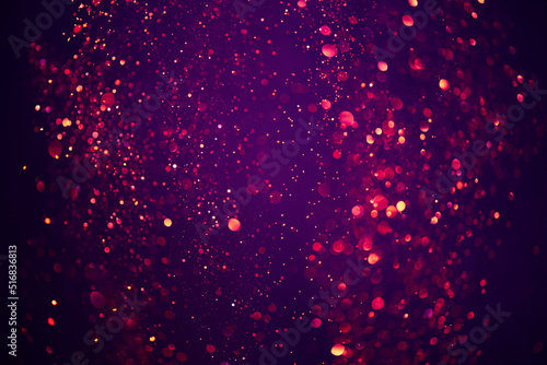 Abstract bokeh background of purple festive shiny glitter lights