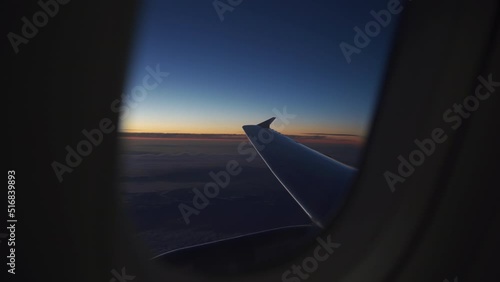 Plane window view at horizon during sunset