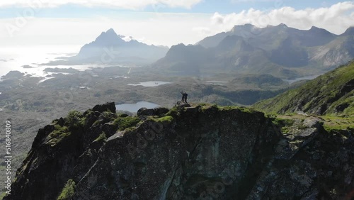 Adventurous couple standing on mountain, enjoying the beautiful view