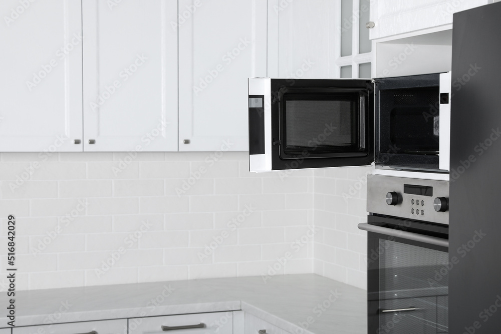 Fototapeta premium Modern oven and microwave in white clean kitchen