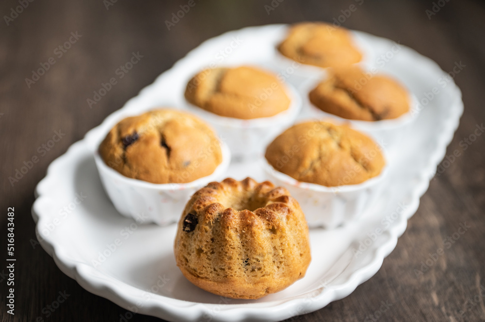 Yummy muffins with chocolate pieces on white plate Yummy muffins with chocolate pieces on white plate
