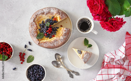 Morning coffee with a piece of german cheesecake kasekuchen with berries on plate on table. Top view, breakfast concept photo