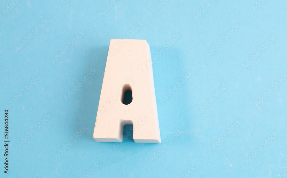 White letter A on a blue background. Letter of the alphabet . The concept is time to school, study White letter A on a blue background. Letter of the alphabet . The concept is time to school, study