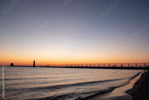 Sunset at the Grand Haven  Michigan  lighthouse and pier on Lake Michigan