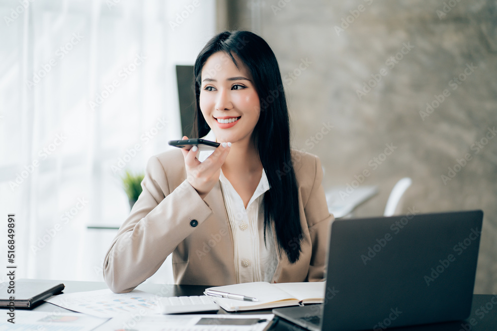 Young asian businesswoman beautiful charming smiling and talking on the mobile phone in the office Young asian businesswoman beautiful charming smiling and talking on the mobile phone in the office