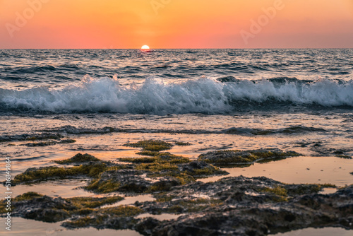 sunset at the beach with waves and colour high quality