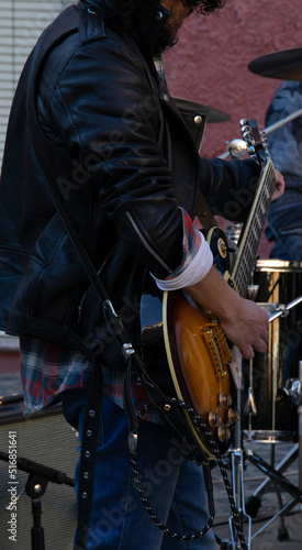 street music, unrecognizable man, playing guitar in the street