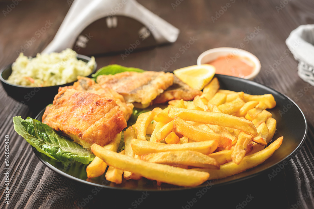 fish and chips on a black plate fish and chips on a black plate