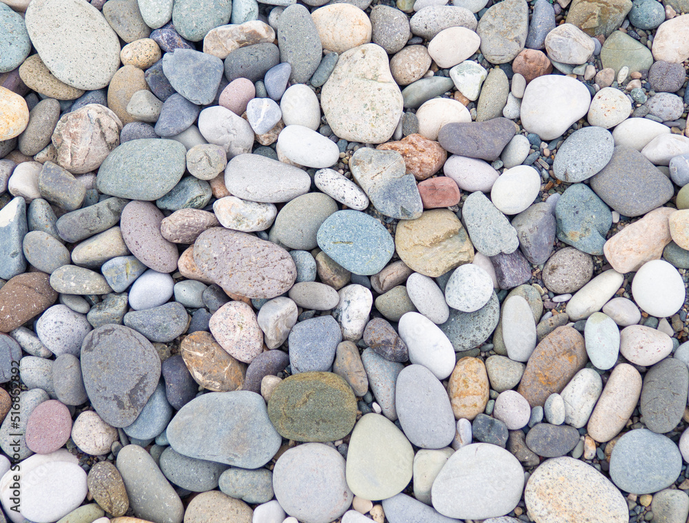 Large beach pebble. Background of small stones. Gray background from stones. Pattern. Large beach pebble. Background of small stones. Gray background from stones. Pattern.