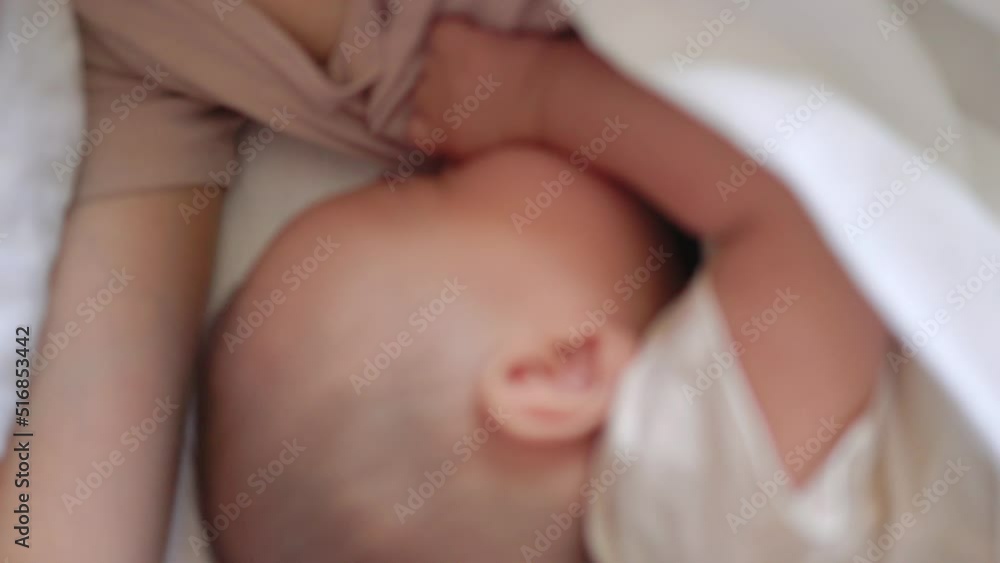 Close up view of Baby fall asleep holding mom on bed Close up view of Baby fall asleep holding mom on bed