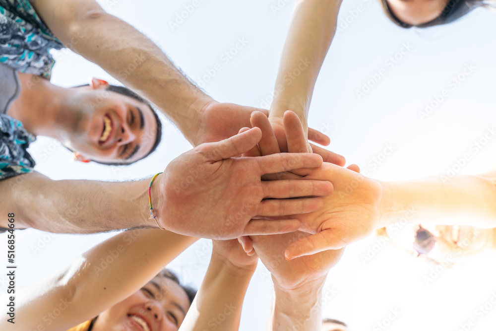 Teamwork, unity concept, group of friends put their hands together.