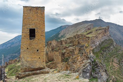 Tower and old houses of the abandoned village of Goor  Dagestan  Russia. Stone town on the rocks. Panoramic view of the ancient Goor settlement among the mountains