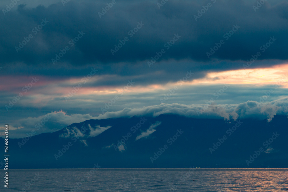 cloudy sunset behind mountains