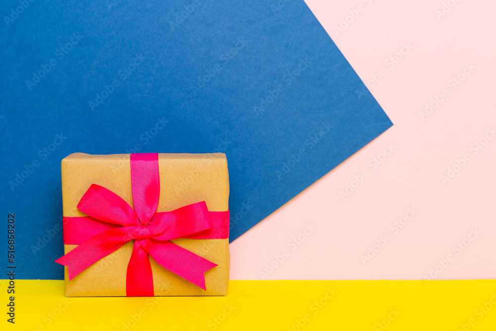 holiday paper present tied pink ribbon bow top view with copy space. Flat lay holiday background. Birthday or christmas present. Christmas gift box concept with copy space holiday paper present tied pink ribbon bow top view with copy space. Flat lay holiday background. Birthday or christmas present. Christmas gift box concept with copy space
