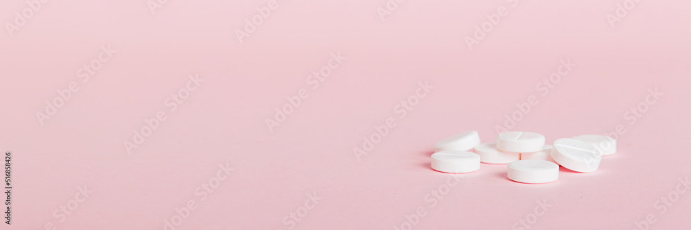 Heap of white pills on colored background. Tablets scattered on a table. Pile of red soft gelatin capsule. Vitamins and dietary supplements concept Heap of white pills on colored background. Tablets scattered on a table. Pile of red soft gelatin capsule. Vitamins and dietary supplements concept