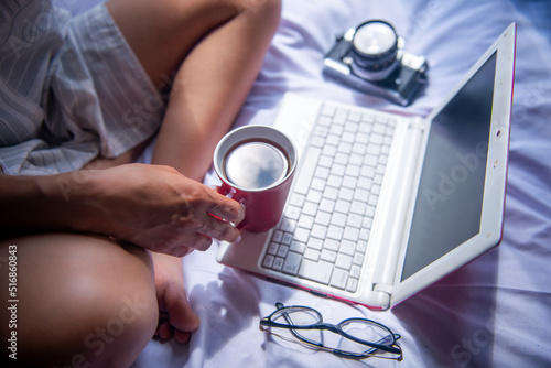 relaxed businesswoman working on her computer with her coffee