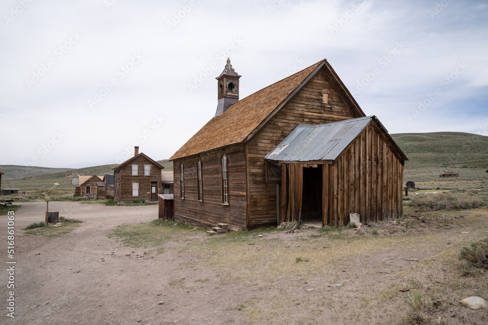 Antique Mining Town In Bodie State Historic Park. Vintage Buildings And Old Mining Equipment Still Standing In Good Condition. Antique Mining Town In Bodie State Historic Park. Vintage Buildings And Old Mining Equipment Still Standing In Good Condition.