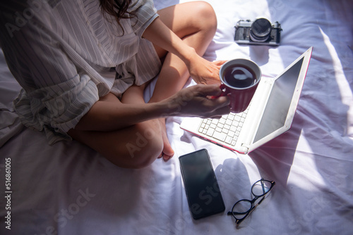 relaxed businesswoman working on her computer with her coffee
