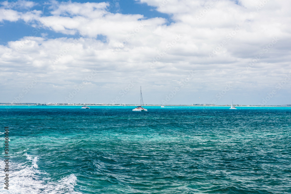 Sailboat and turquoise clear water, blue water, Caribbean ocean, Isla Mujeres, Cancun, Yucatan, Mexico Sailboat and turquoise clear water, blue water, Caribbean ocean, Isla Mujeres, Cancun, Yucatan, Mexico