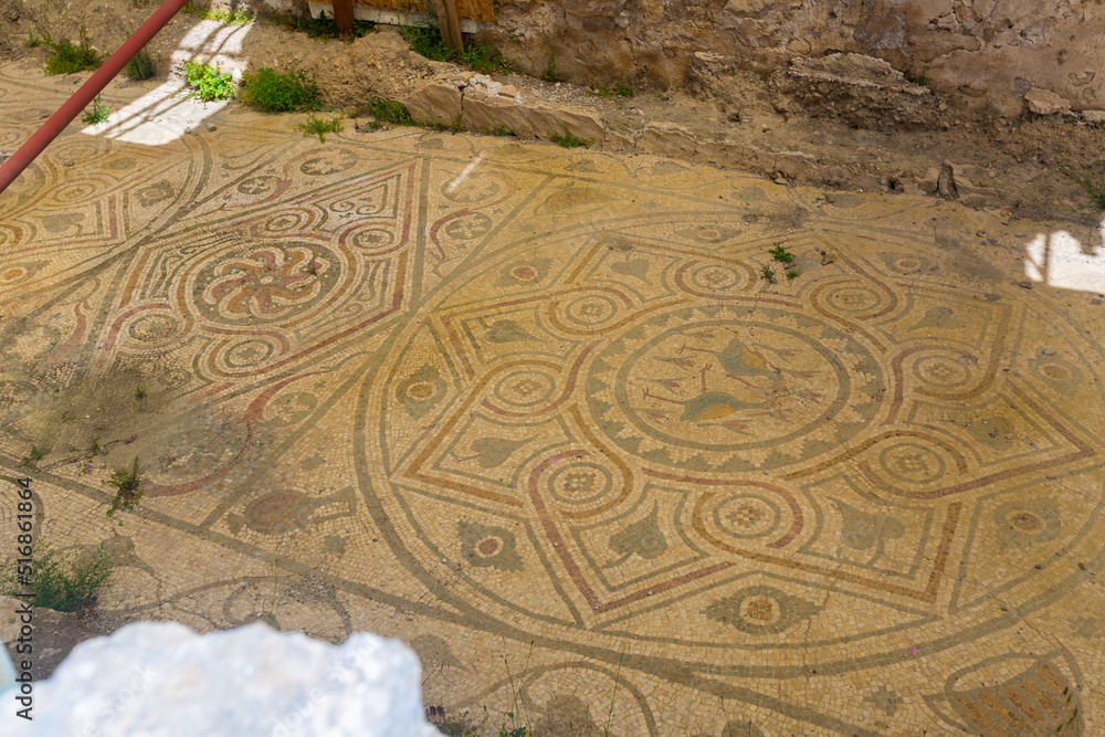 Remains of old colored mosaics on floor of ruined building in Turkish city of Arykanda. Art of ancient civilizations. Historical archaeological sites in Antalya province