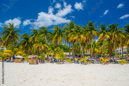 Cocos beach bar on a beach with white sand and palms on a sunny day, Isla Mujeres island, Caribbean Sea, Cancun, Yucatan, Mexico