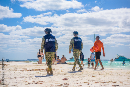Militaries walking along the beach with machine guns, Isla Mujeres island, Caribbean Sea, Cancun, Yucatan, Mexico