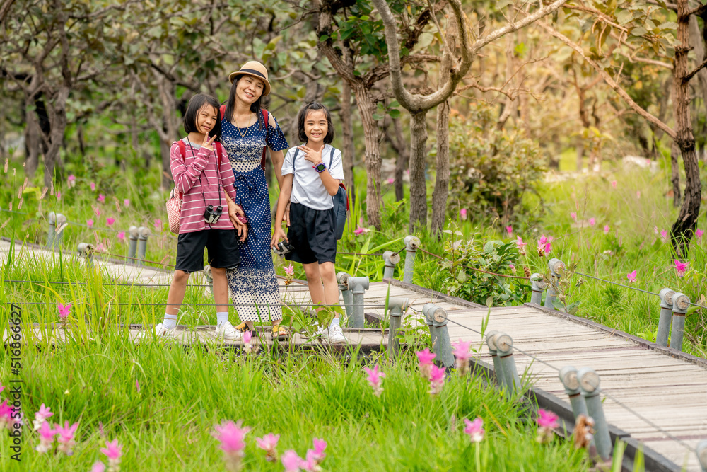 Fototapeta premium Children and parents travel and journey in forest of summer holiday season, lovely family people in beautiful nature
