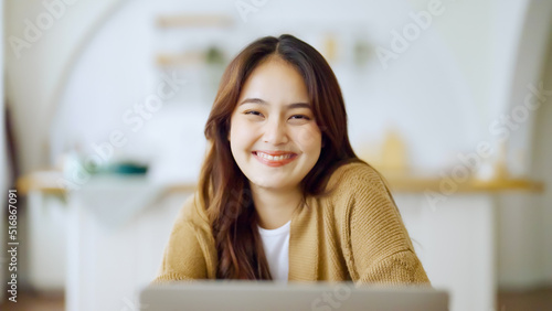 Portrait smiling asian young woman looking to camera. Facial expression happy