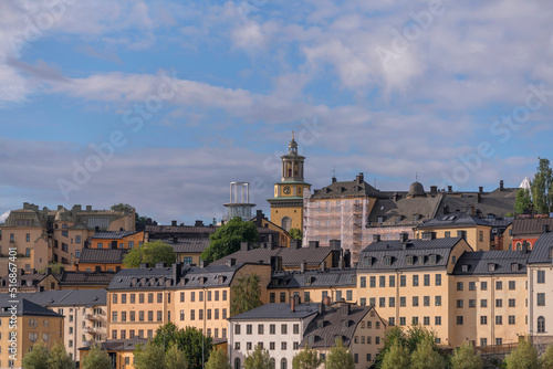 Old 1800s houses at the water front in the block at the street Bastugatan, a sunny summer day in Stockholm photo