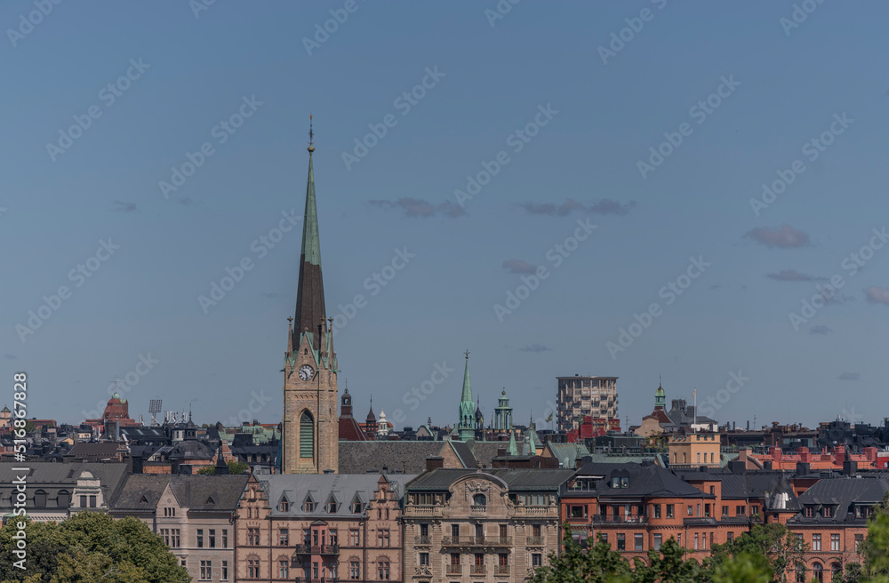 Roofs of apartment houses and churches in the district Östermalm, a sunny summer day in Stockholm