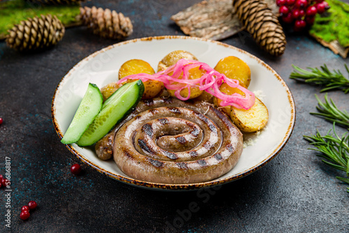 bavarian sausages with potatoes and red onion on plate