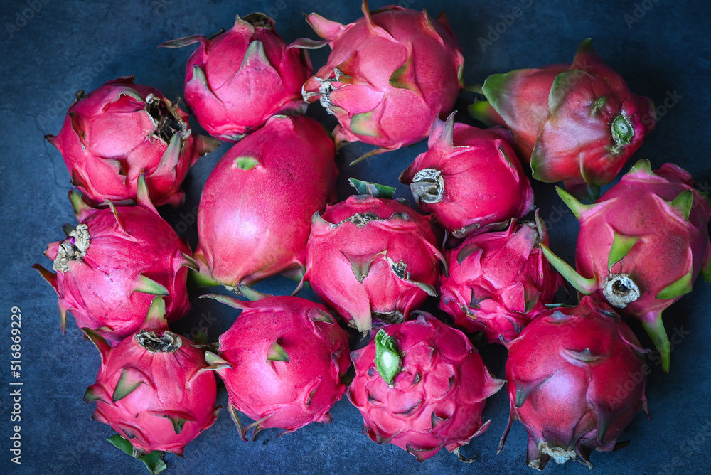 dragon fruit pitahaya on dark background , fresh dragon fruit tropical in the asian thailand healthy fruit concept - top view dragon fruit pitahaya on dark background , fresh dragon fruit tropical in the asian thailand healthy fruit concept - top view