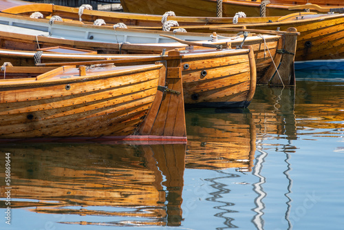 Traditional wooden rowboats lined up in the harbor. photo