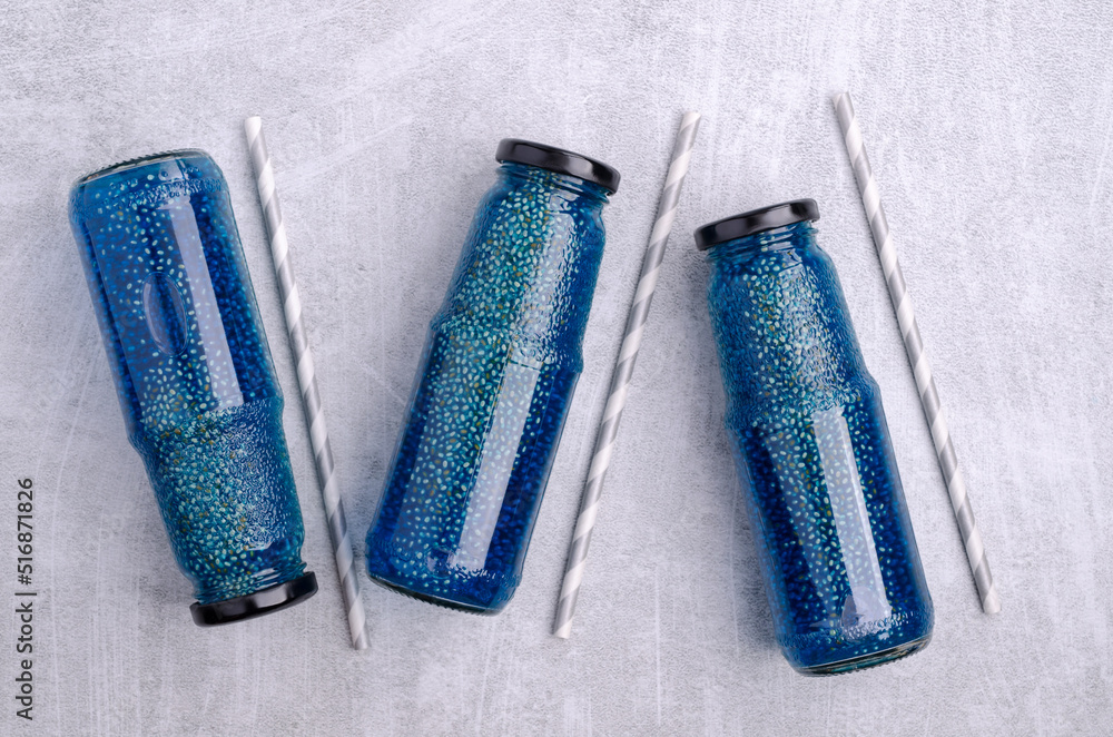 Naklejka premium Transparent blue drink with chia seeds