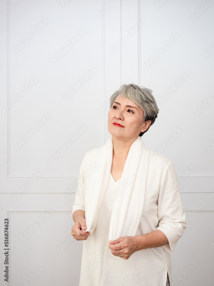 Portrait of mature aged asian woman 50s with towel at home. Portrait of mature aged asian woman 50s with towel at home.