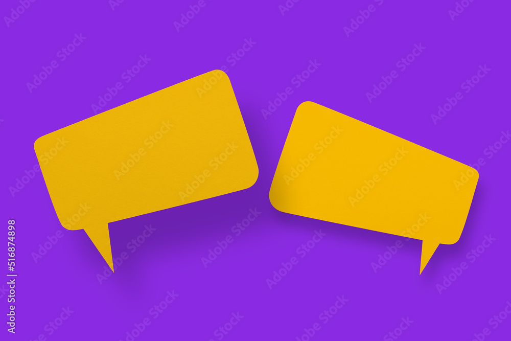 Speech balloon shaped yellow paper against a purple background. Speech balloon shaped yellow paper against a purple background.